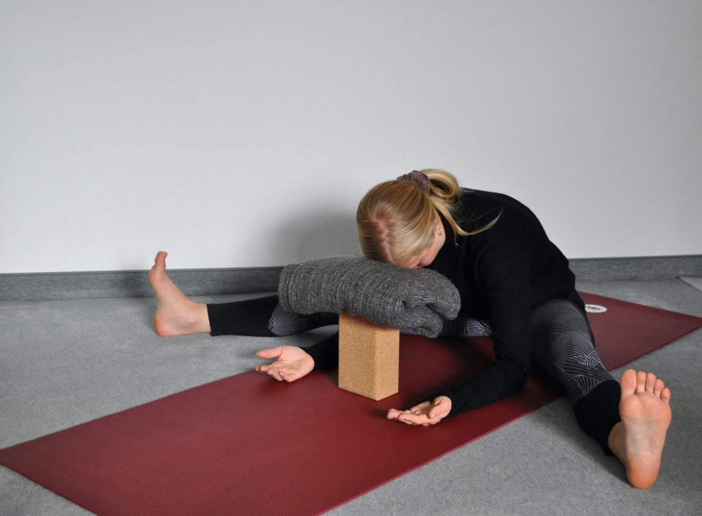 Wide-angle forward fold with hands on floor