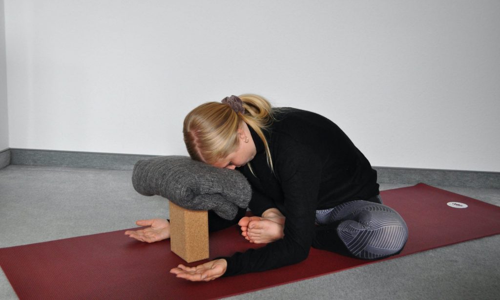 Seated butterfly pose folding forward toward floor