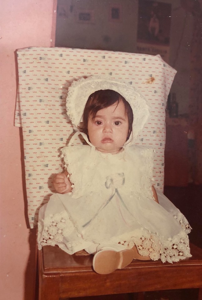 Baby Mari Silvia held in her family's arms
