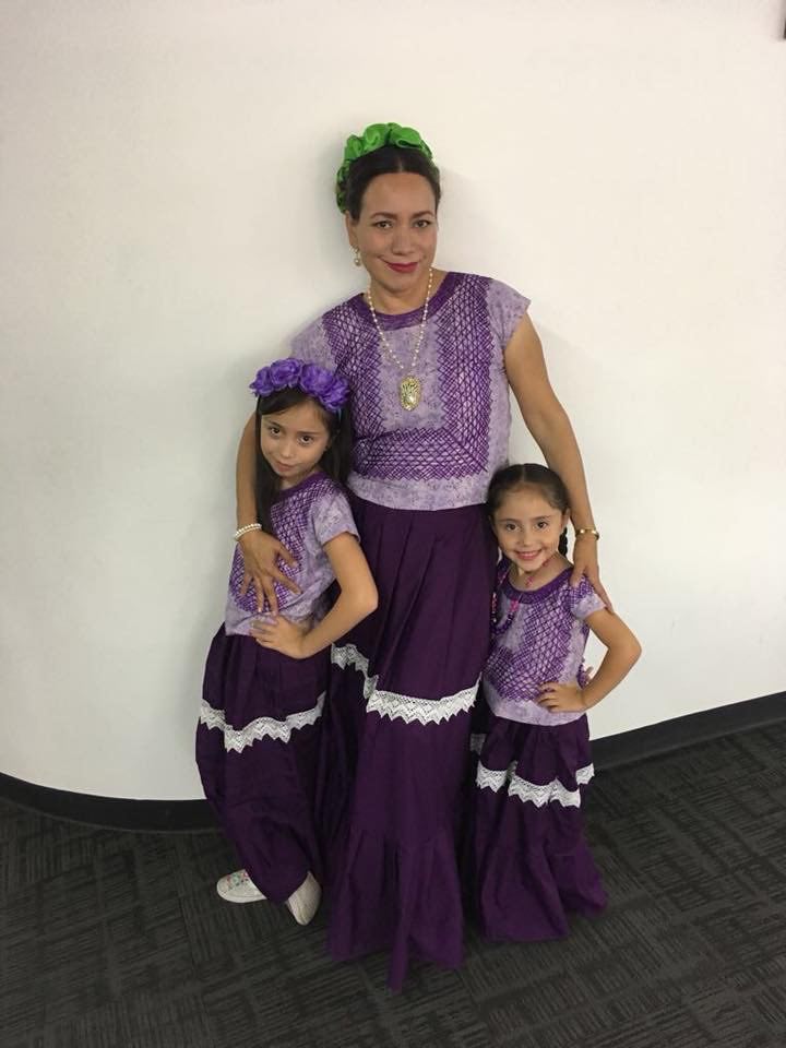 Mari Silvia with her two daughters smiling together