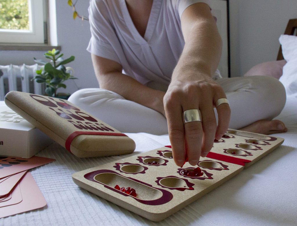 OH WOMAN board game components arranged on table for discussion