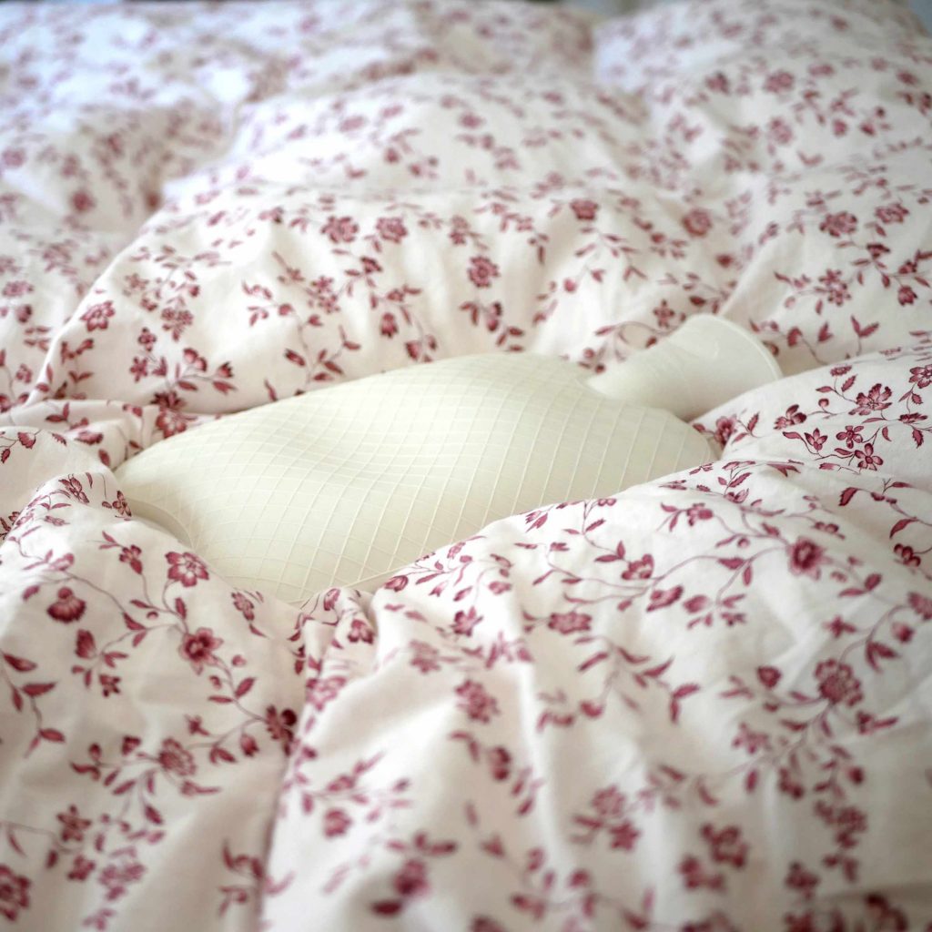 Person resting at home during period with a hot water bottle