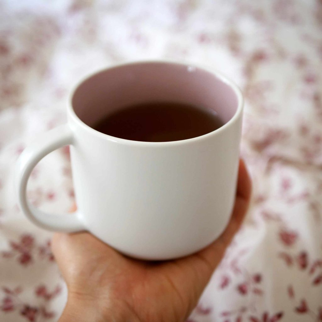 Woman relaxing comfortably at home during her menstrual period